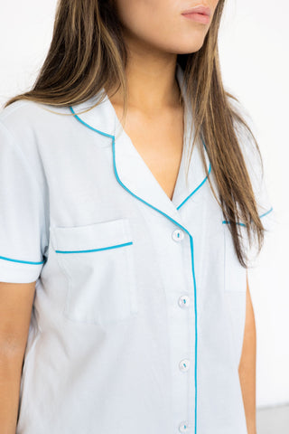Women wearing soft light blue short sleeve pajama top