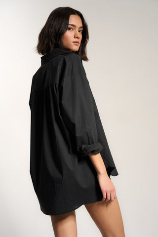 Woman wearing black cotton button up shirt