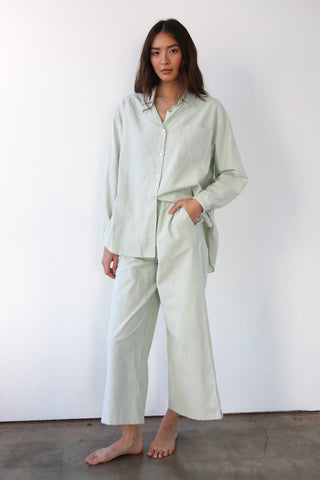 Woman wearing green and white pinstripe lounge pants