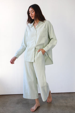 Woman wearing green and white pinstripe boxer pants