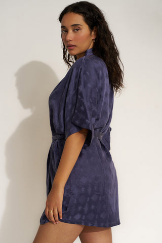 Woman wearing short navy blue robe.