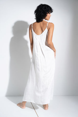 Woman wearing soft long white nightgown.