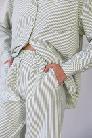 Woman wearing green and white pinstripe lounge pants