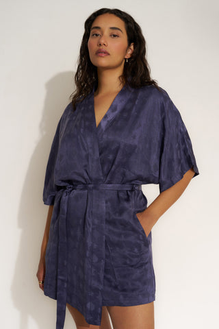 Woman wearing short navy blue robe.