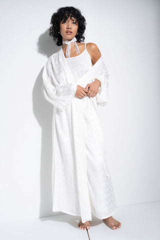 Woman wearing long white robe.