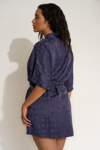 Woman wearing short navy blue robe.