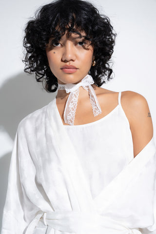 Woman wearing long white robe.