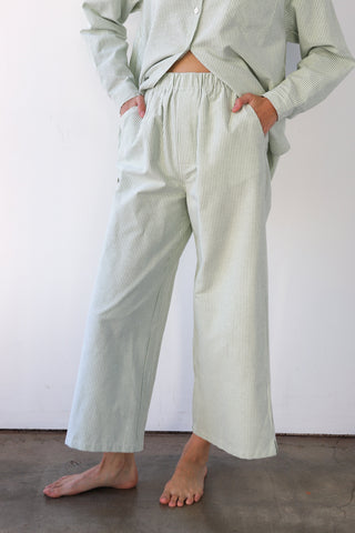 Woman wearing green and white pinstripe boxer pants