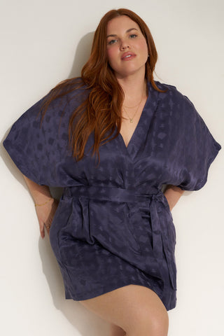 Woman wearing short navy blue robe.