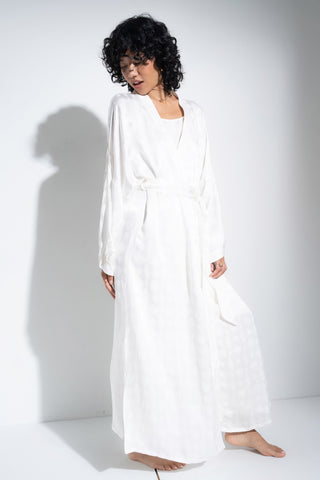 Woman wearing long white robe.