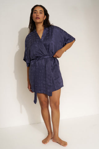 Woman wearing navy blue short robe.
