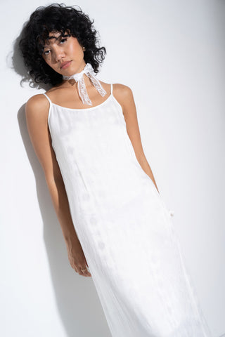 Woman wearing soft long white nightgown.