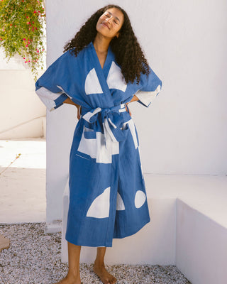 Woman wearing a blue and white patterned robe.