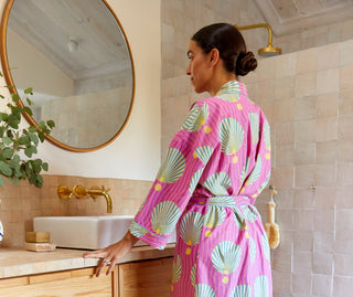 Woman wearing a pink robe with shell details