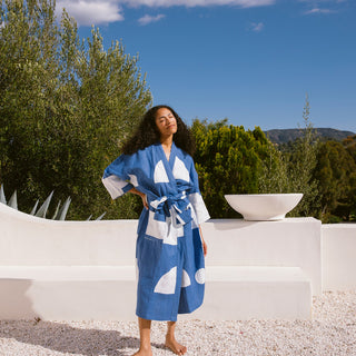 Woman wearing hand block printed blue and white patterned robe.