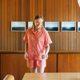 Stylish women’s pajama set featuring contrast orange sherbet color, piping detail and soft elastic waistband shorts