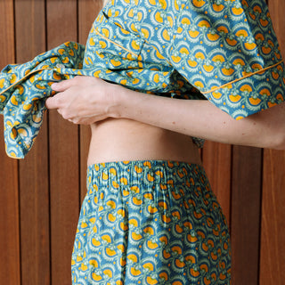 Woman wearing Block Shop short cotton sleepwear set in blue and yellow marigold pattern