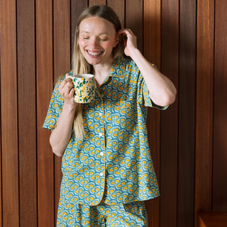 Woman wearing blue and yellow marigold pattern short PJs