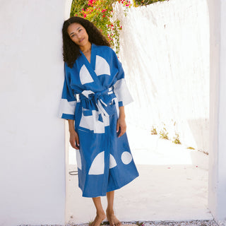 Woman wearing geometric blue and white patterned robe.