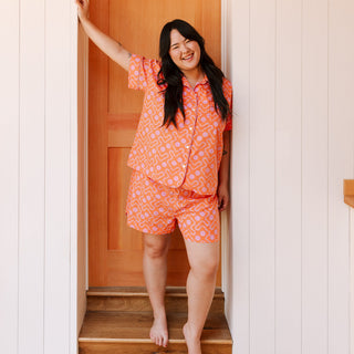 Women wearing orange lightweight short pajama set from Block Shop