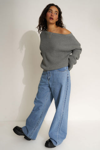 Woman wearing a gray off-shoulder sweater