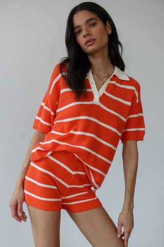 Woman wearing red and white stripe knit shorts with matching polo shirt