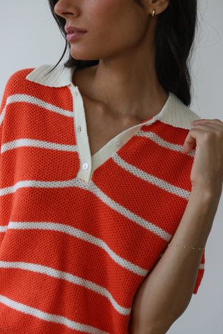 Woman wearing red and white striped knit polo shirt