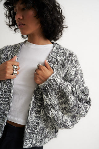 Woman wearing cute oversized grey cardigan sweater