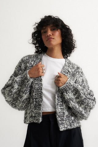 Woman wearing soft knit grey cardigan sweater