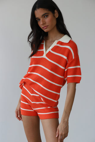 Woman wearing red and white striped knit polo shirt with matching shorts