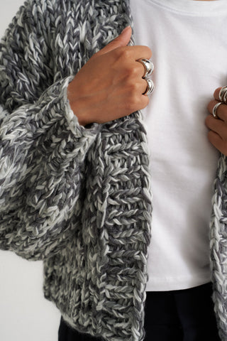 Woman wearing cozy knit cardigan in grey