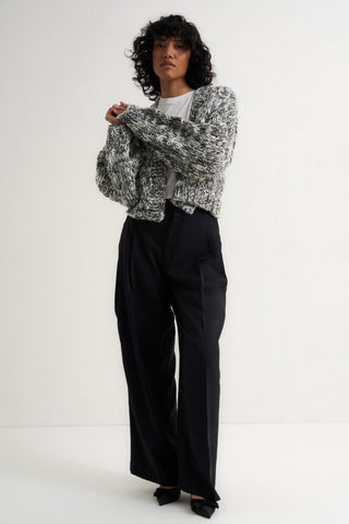 Woman wearing chunky knit grey cardigan sweater