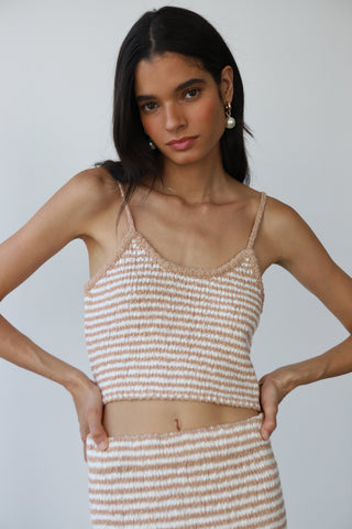 Woman wearing a beige and white striped cotton knit maxi skirt with matching tank