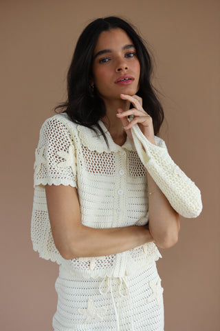 Woman wearing a summery white crochet outfit set