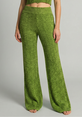 Woman wearing green knit tank with matching knit bell bottom pants.