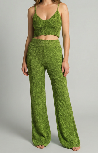 Woman wearing green knit tank with matching knit bell bottom pants.