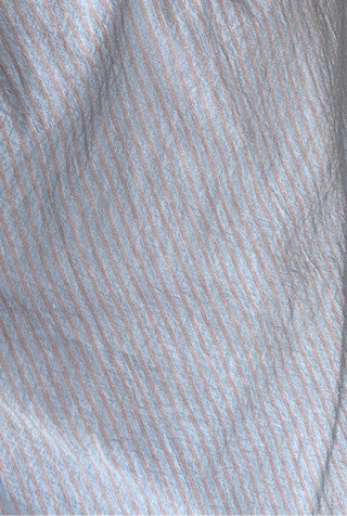 Close-up of light blue fabric with thin pink stripes