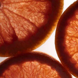 Close-up of sliced grapefruits with a white background
