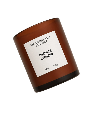 Amber glass jar with white label featuring Sensory Riot Pumpkin Liqueur Candle
