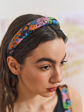 Woman wearing a colorful black and floral headband