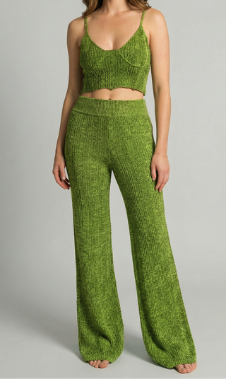 Green knitted crop tank top with matching knitted bell bottom pants on a gray background