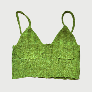 Green knitted crop top on a light gray background