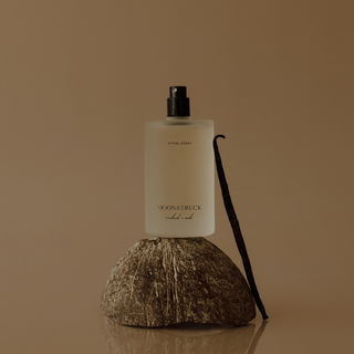 Moonstruck Ritual Spray shown over a coconut