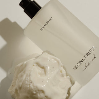Moonstruck  ritual spray bottle with a scoop of vanilla ice cream on a light background