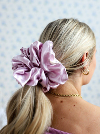 Girl with blonde ponytail wearing a lavender silk scrunchie
