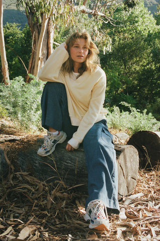 Woman wearing soft yellow sweatshirt