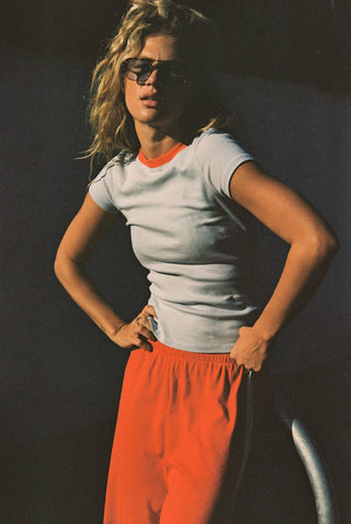 Woman wearing baby blue t-shirt with red neckline