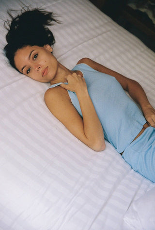 Woman wearing light blue pointelle tank top