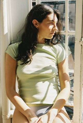 Woman wearing pistachio colored soft cotton rib short sleeve tee
