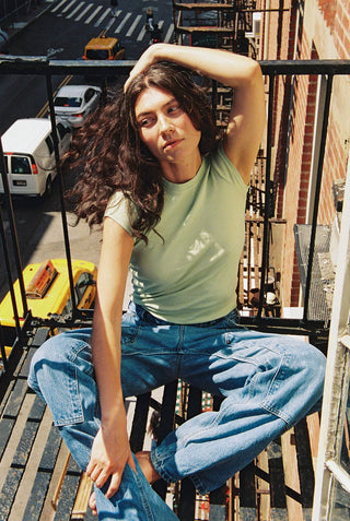 Woman wearing pistachio green short sleeve cotton shirt